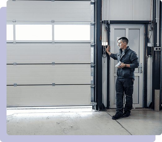 Man standing by industrial garage door.
